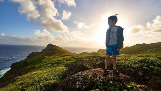 Kid standing on rock