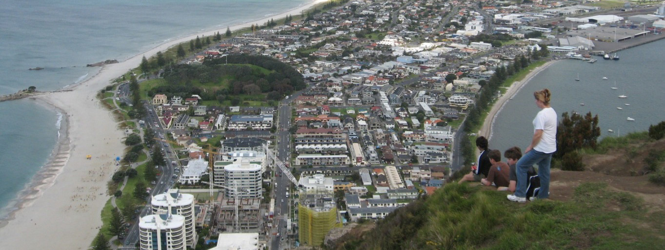 People sitting on top of Mt Manganui overlooking the Mout